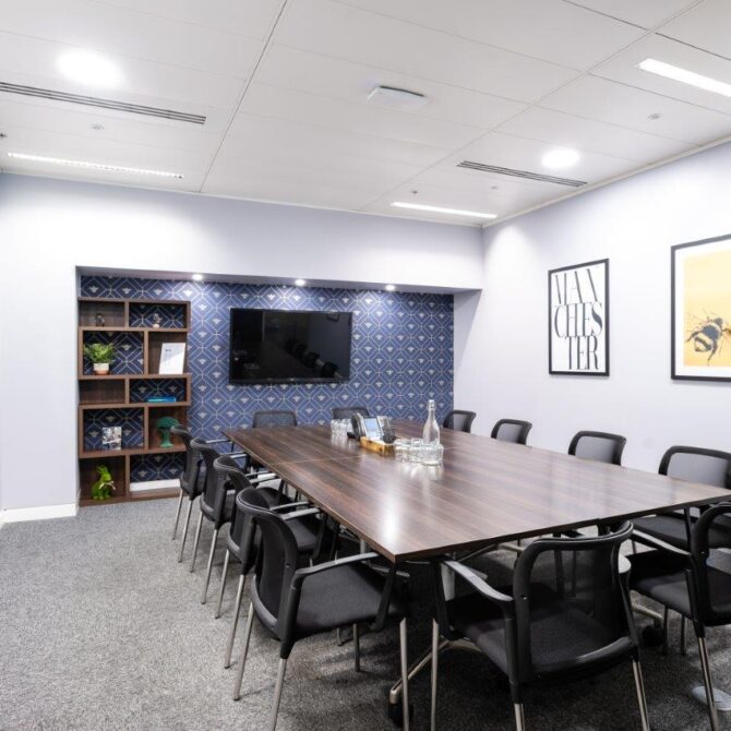 Modern meeting room in Manchester with spacious table, ideal for team brainstorming sessions.