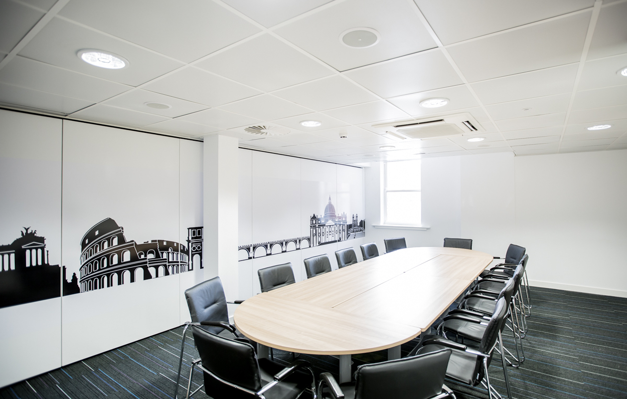 Modern meeting room with oval table, ideal for corporate events and workshops.