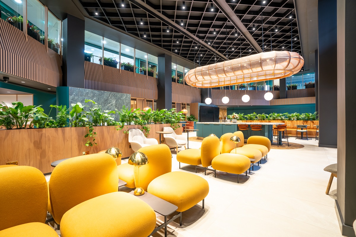 Modern business lounge with vibrant yellow seating, perfect for networking events.