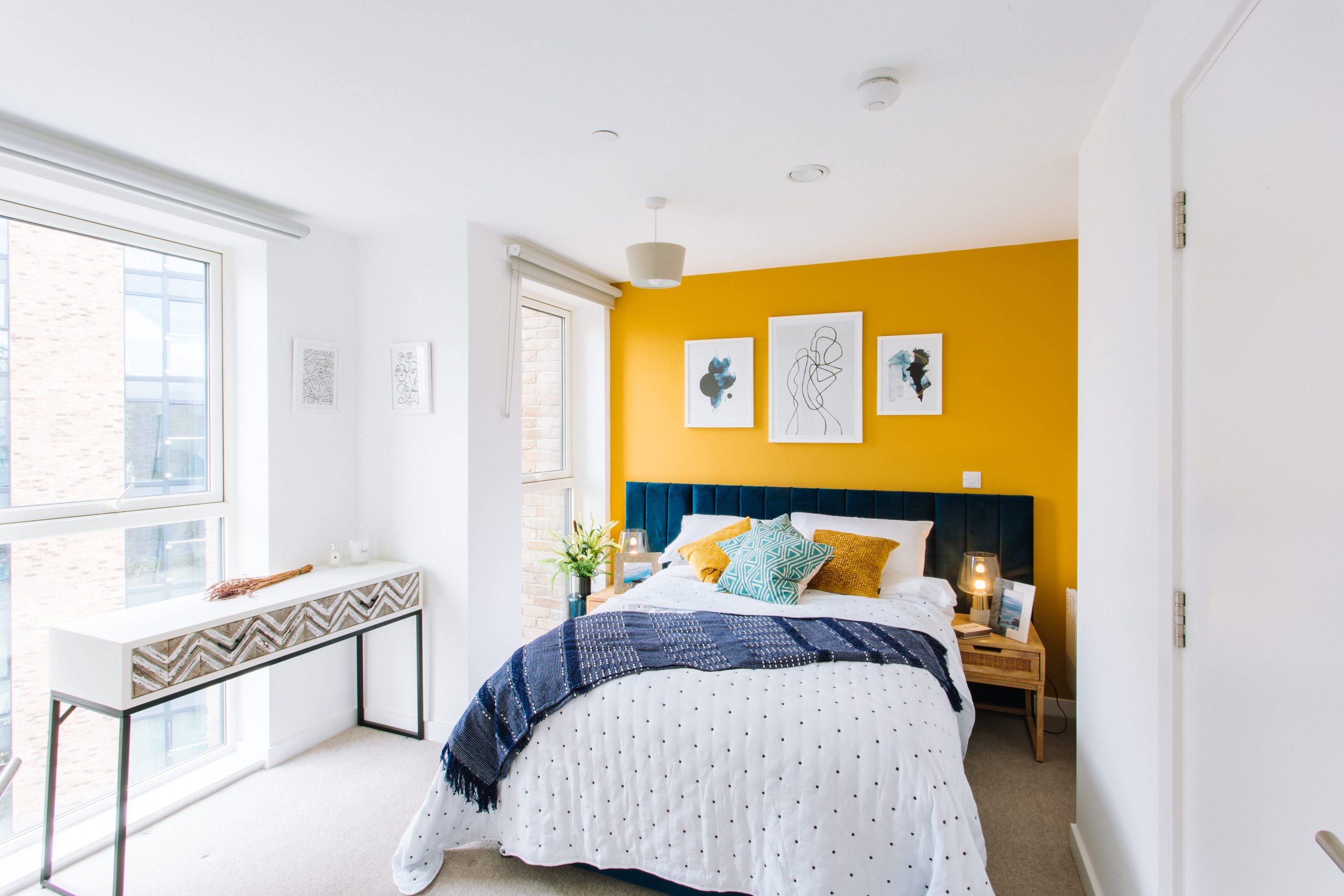 Cozy guest room with vibrant wall for events at Clippers in The Buzz Rooms.