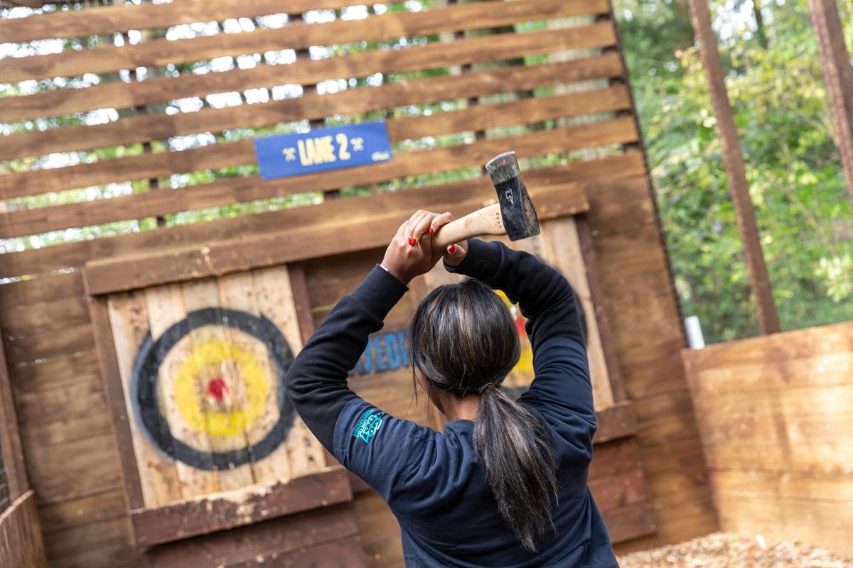 Axe throwing participant at Go Ape Rivington, ideal for team-building events.