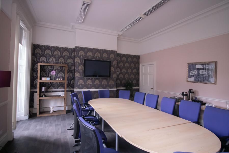 Meeting room in Portal Business Centre with ergonomic chairs, ideal for conferences and presentations.