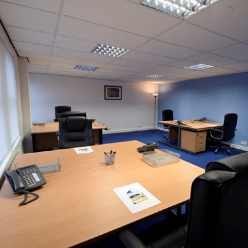 Spacious meeting room with ergonomic chairs for collaborative work sessions at Portal Business Centre.