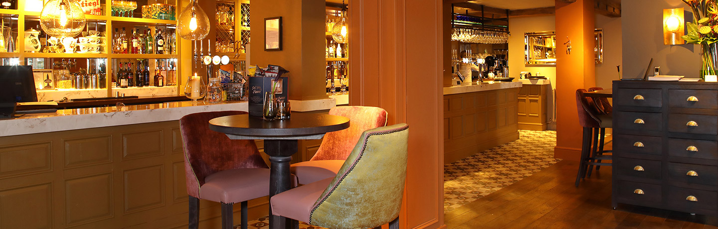 Cozy bar with warm lighting, perfect for networking events and meetings.