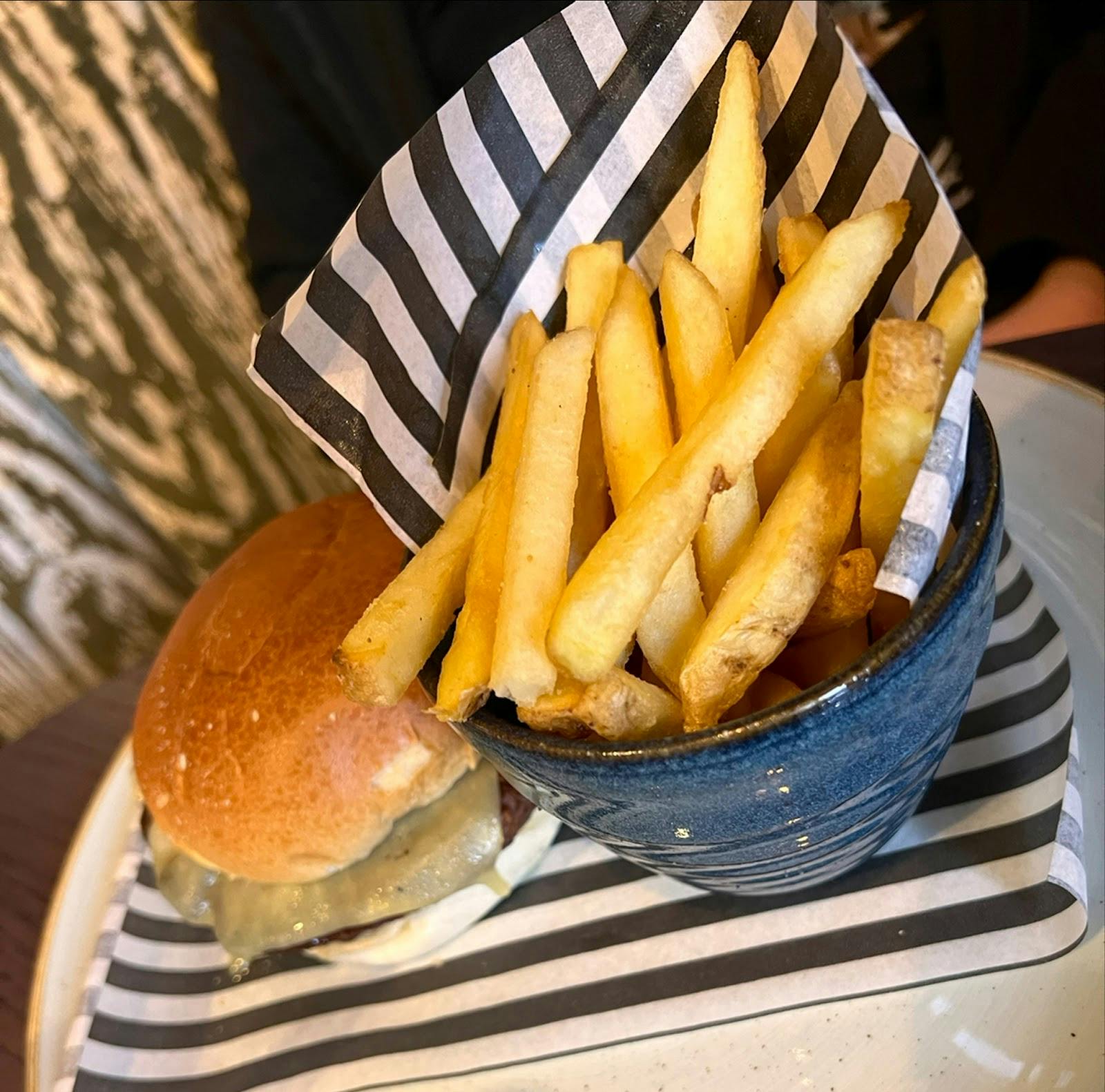 Well-presented burger and fries in The Garden at The Merlin, perfect for events.