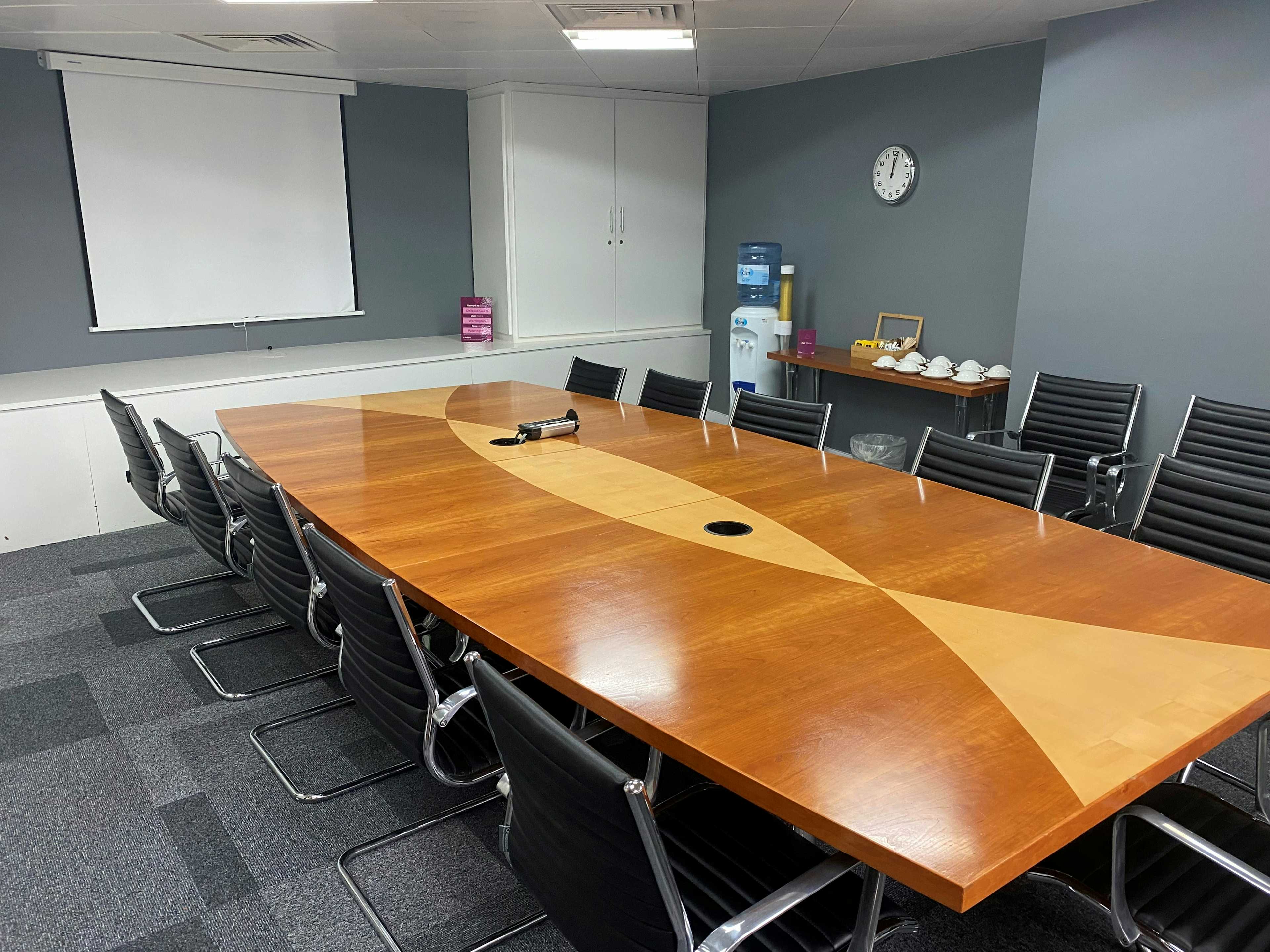 UBC Flexible Offices conference room with polished table, perfect for professional meetings.