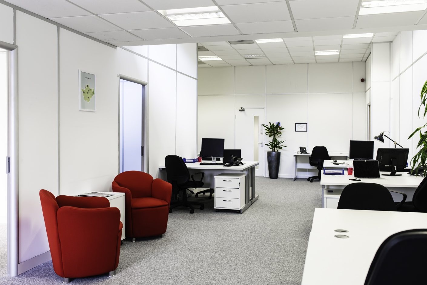 Modern UBC office space with red chairs, ideal for meetings and events planning.