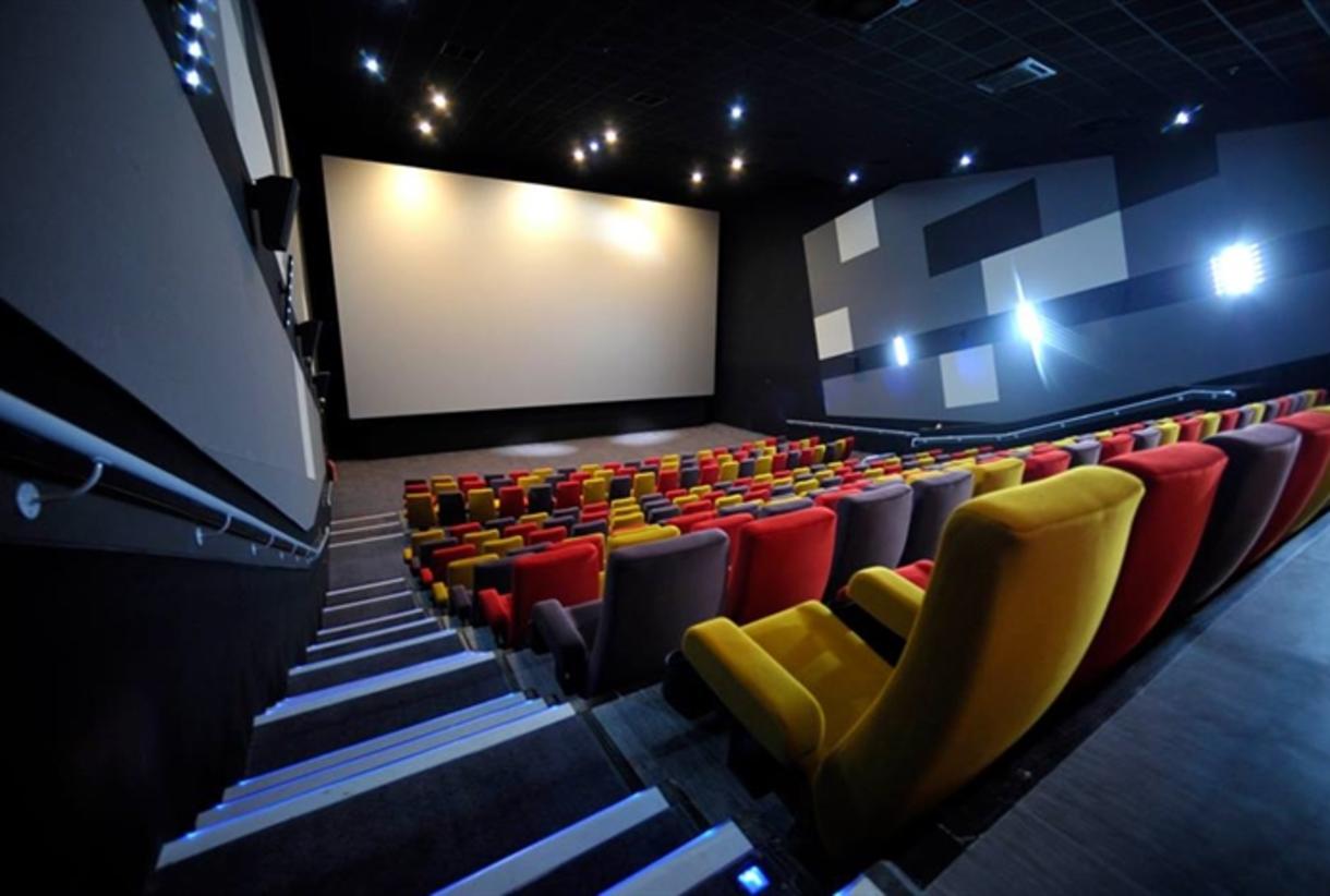 Modern cinema auditorium with tiered seating, perfect for film premieres and corporate events.