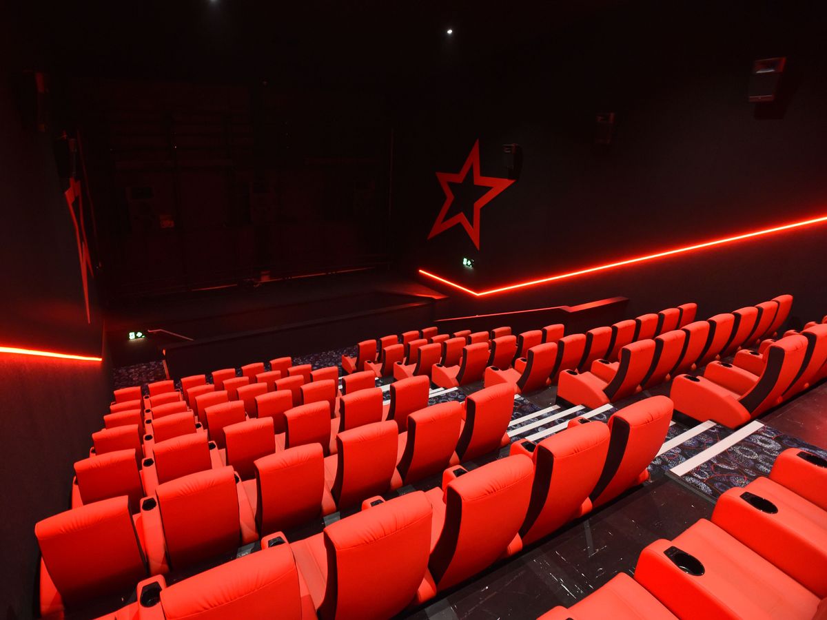 Modern auditorium in The Light Bolton with red seating, ideal for presentations or screenings.