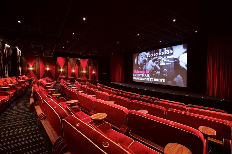 Modern cinema space with plush red seating, ideal for corporate events and screenings.