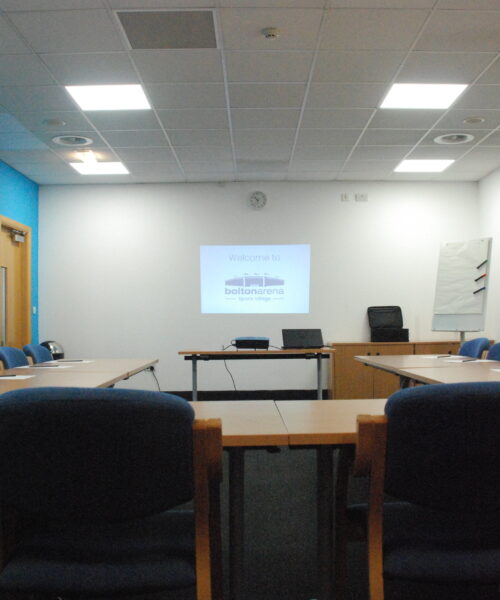 Conference Room at Bridge School with projector set up for professional meetings.