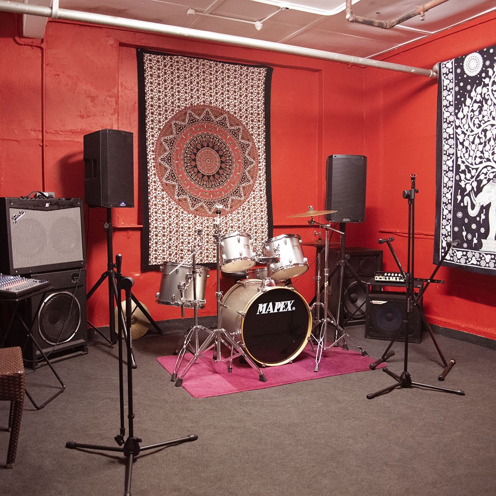 Vibratone Sound Studio rehearsal space with drum kit, ideal for live music events and workshops.