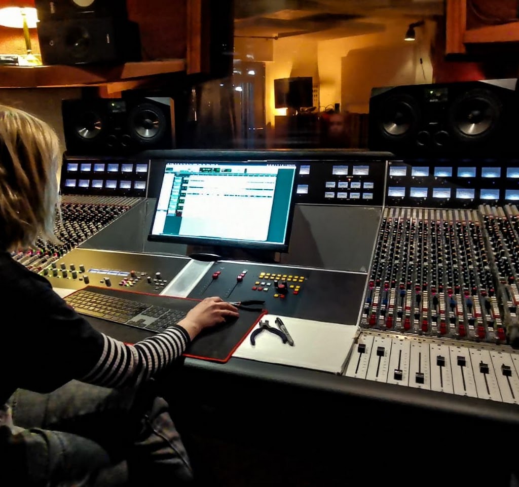 Modern audio production studio with a sound mixing console for events and presentations.