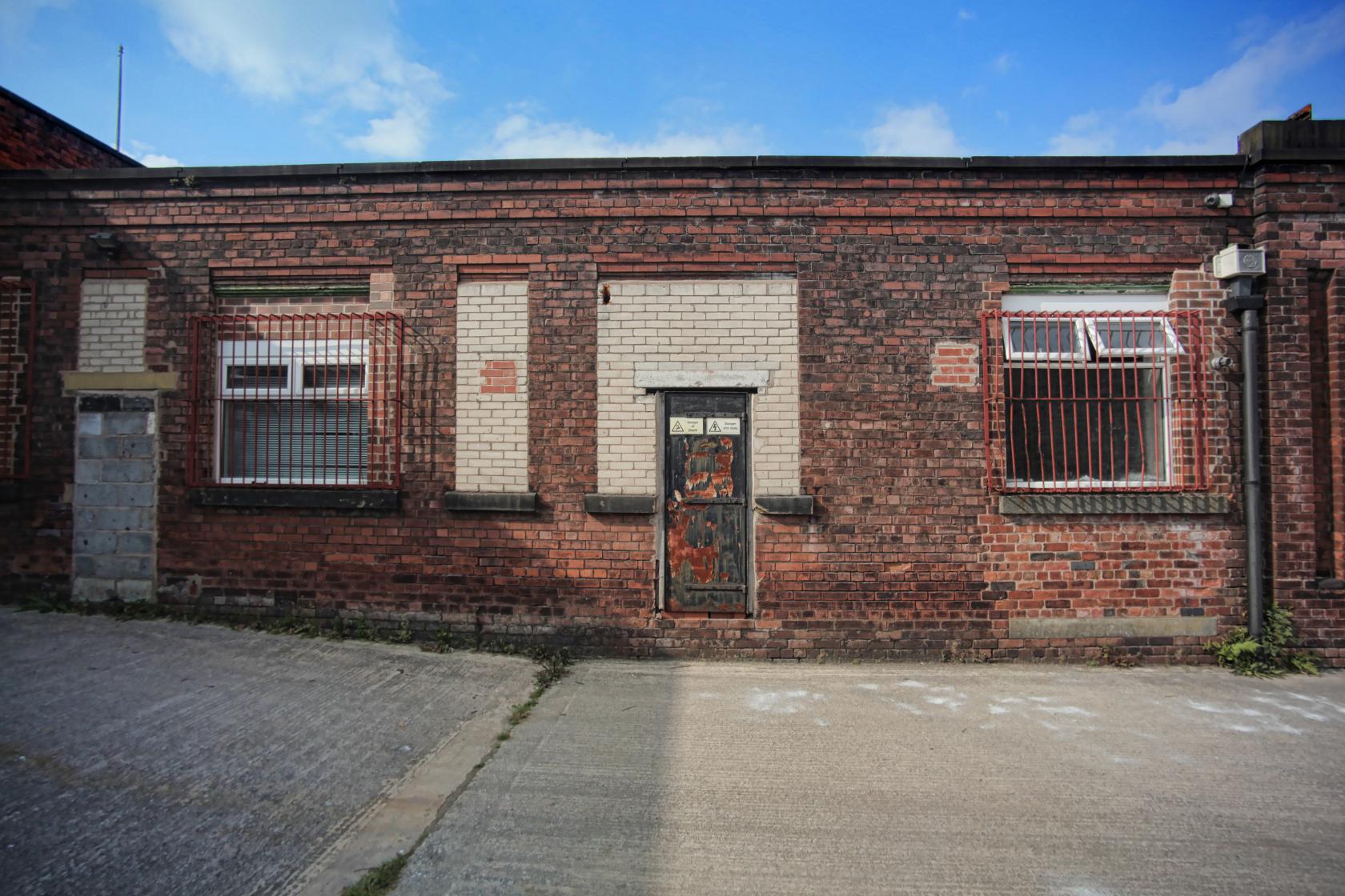 Rustic brick building at Sitcom Soldiers, ideal for creative meetings or events.