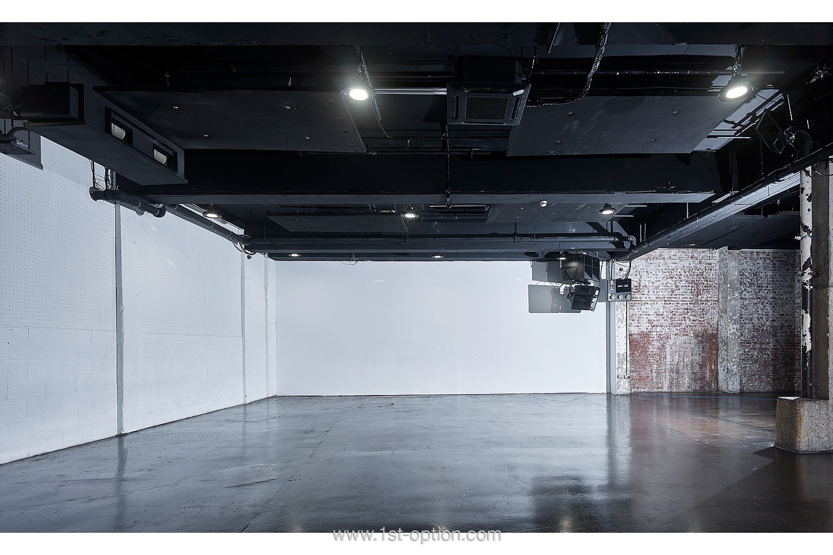 Cubed seating boxes in a versatile, minimalist event space for corporate meetings and showcases.