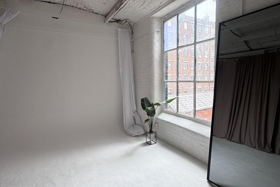 Cubed seating boxes in a minimalist event space for meetings and workshops.