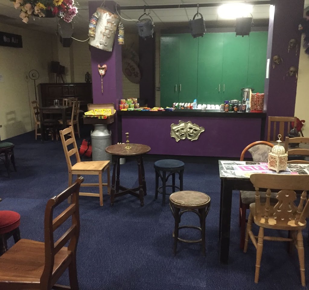 Cozy event space with purple walls for gatherings at North West Theatre Arts Company.