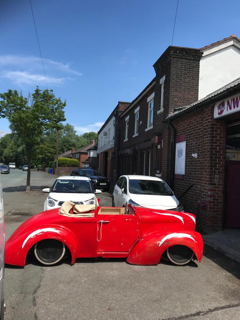 Vibrant red classic car prop for themed events at NWTAC Theatre, enhancing vintage celebrations.
