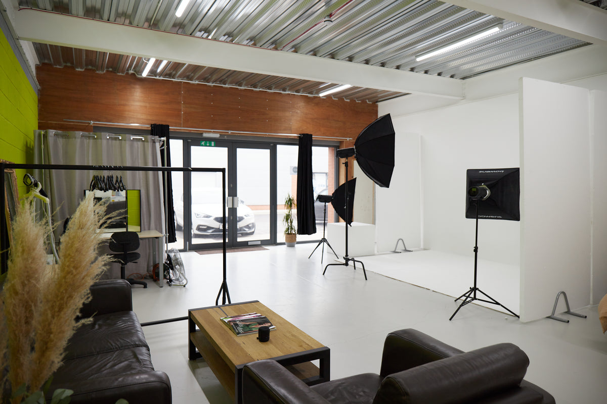 Versatile Studio 2 for meetings and events with clean white backdrop and cozy seating.