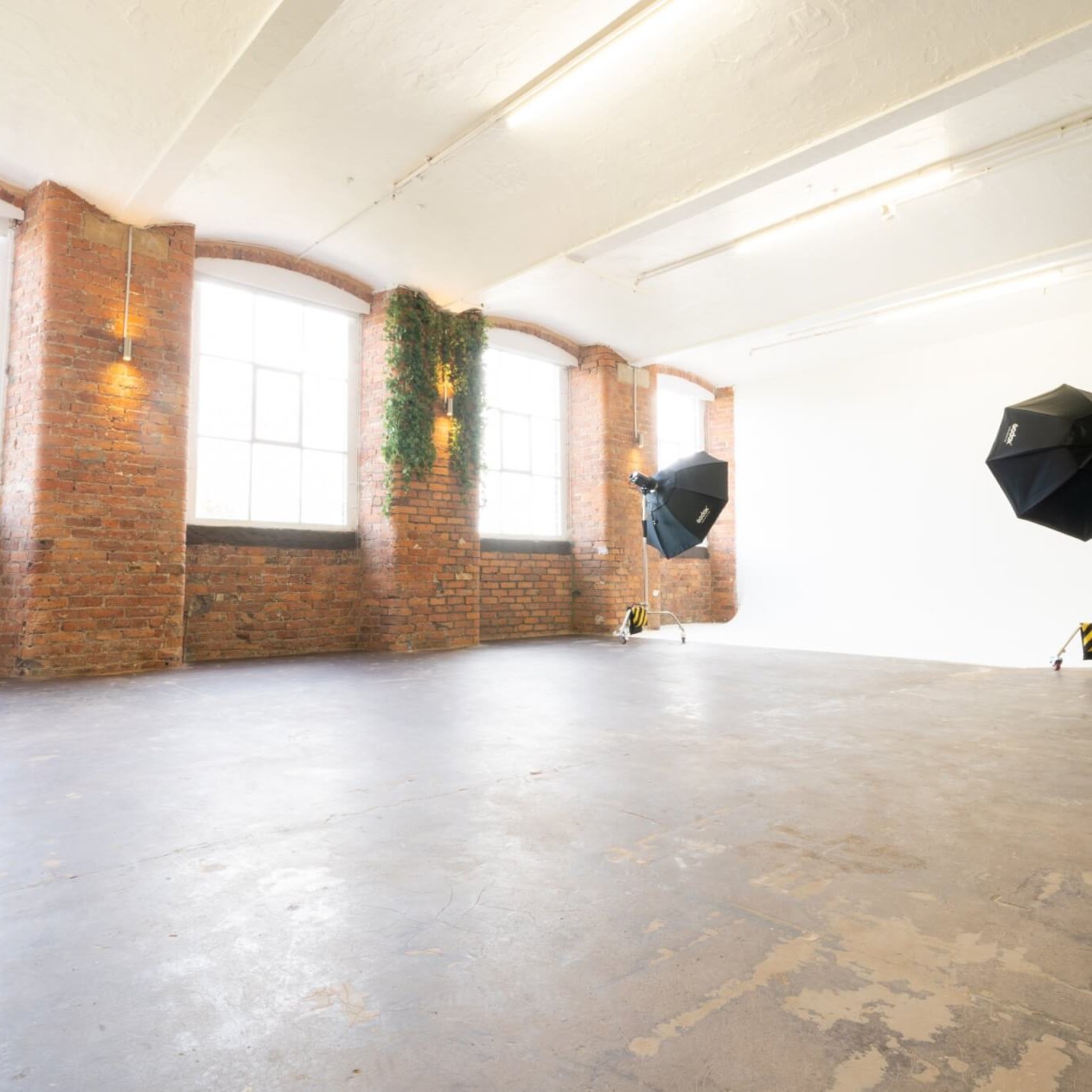 Spacious Studio 2 venue with exposed brick walls for creative events and photoshoots.