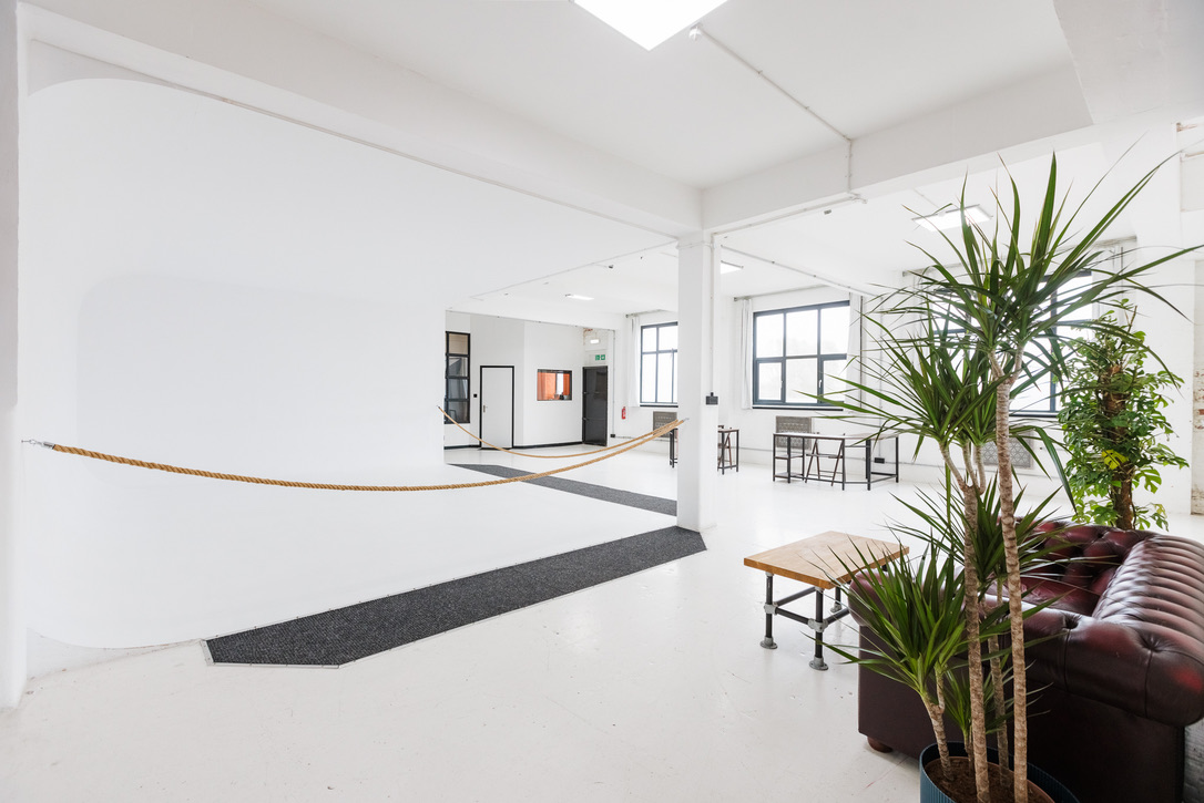 Modern event space in Spectrum Studios with natural light for gatherings and brainstorming.