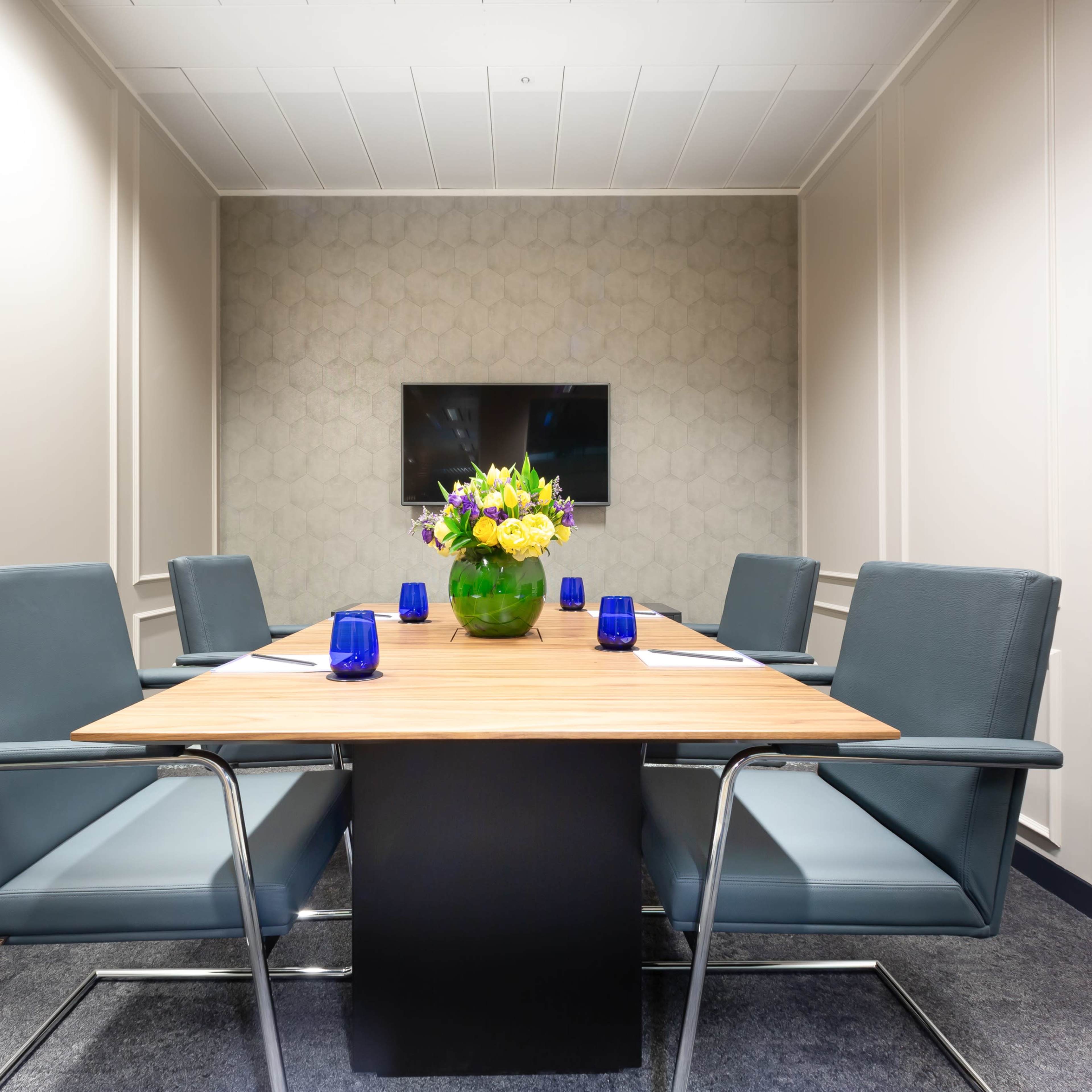 Modern meeting room with polished table, ideal for corporate events or presentations.