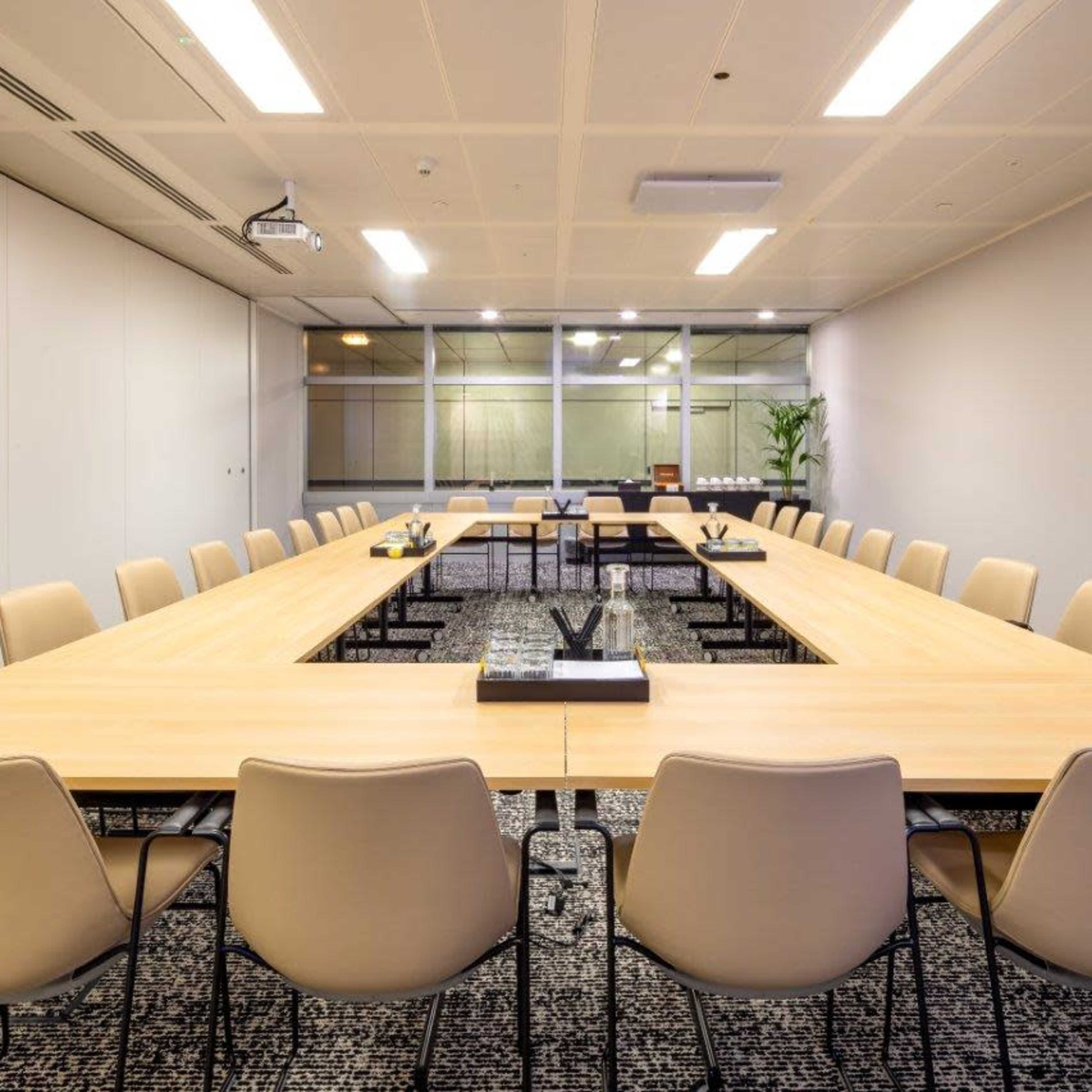 Modern conference room with large table, ideal for meetings and workshops.