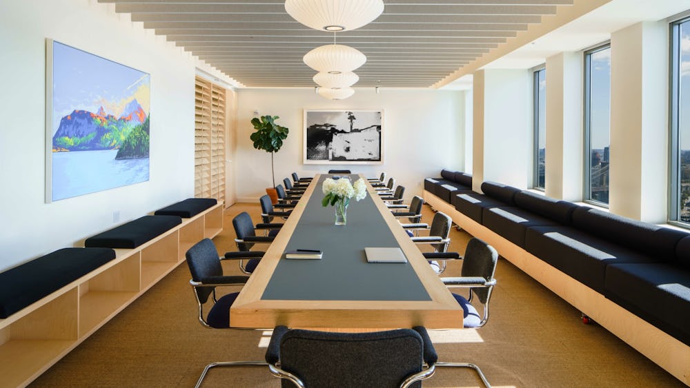 Modern meeting room with sleek table and ergonomic chairs for corporate events.