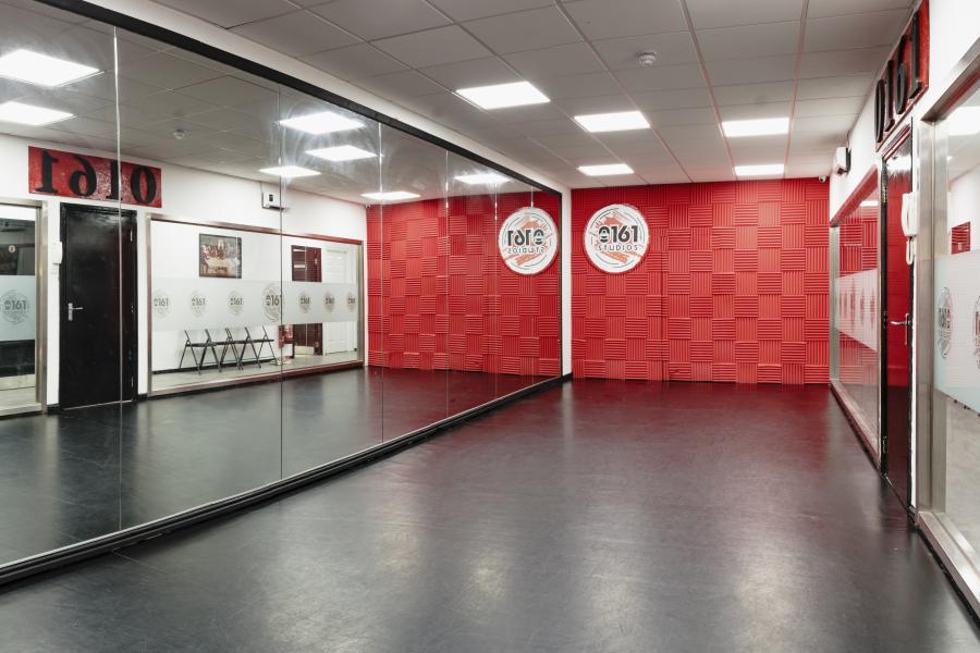 Versatile dance studio with mirrored walls, ideal for workshops and fitness classes.