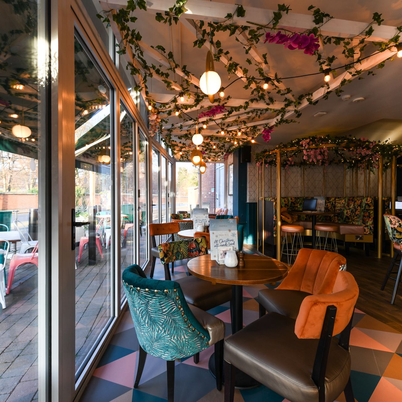 Charming event space at Slug And Lettuce Didsbury with cozy seating and greenery.