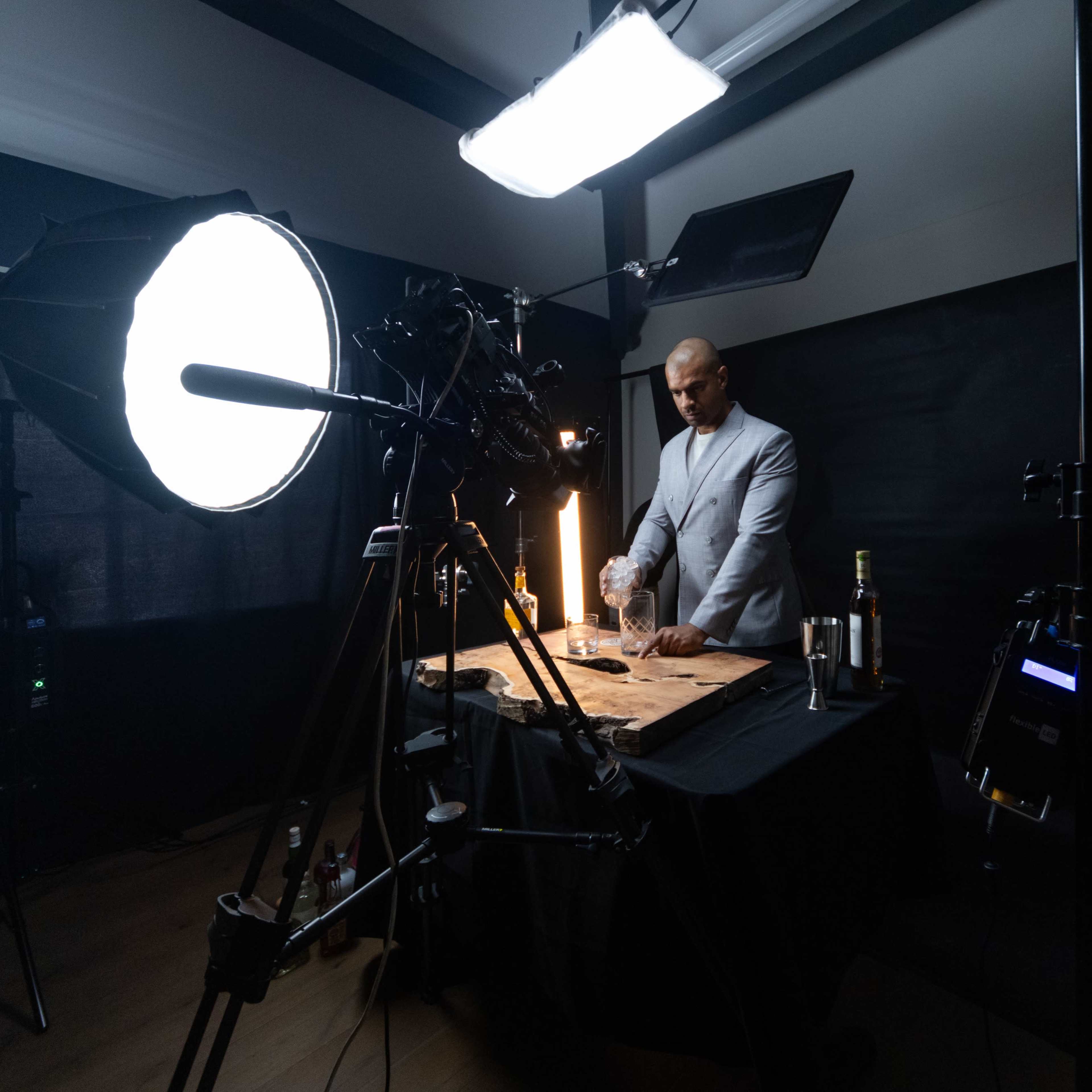 Sophisticated virtual event studio with professional backdrop and mixologist setup