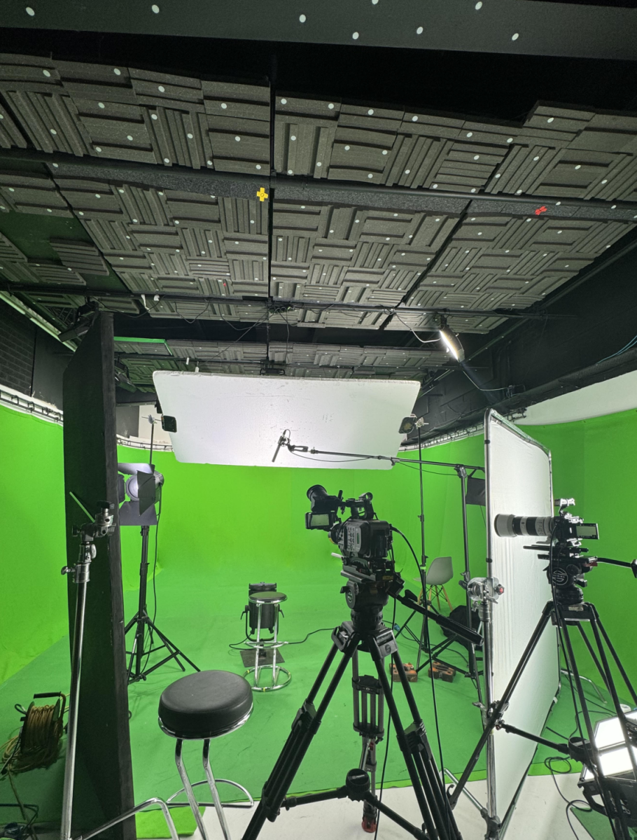 Professional podcast studio with green screen for virtual events and livestreaming.