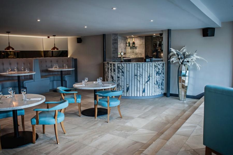 Chic function room with marble decor at KickSonic for intimate meetings and events.