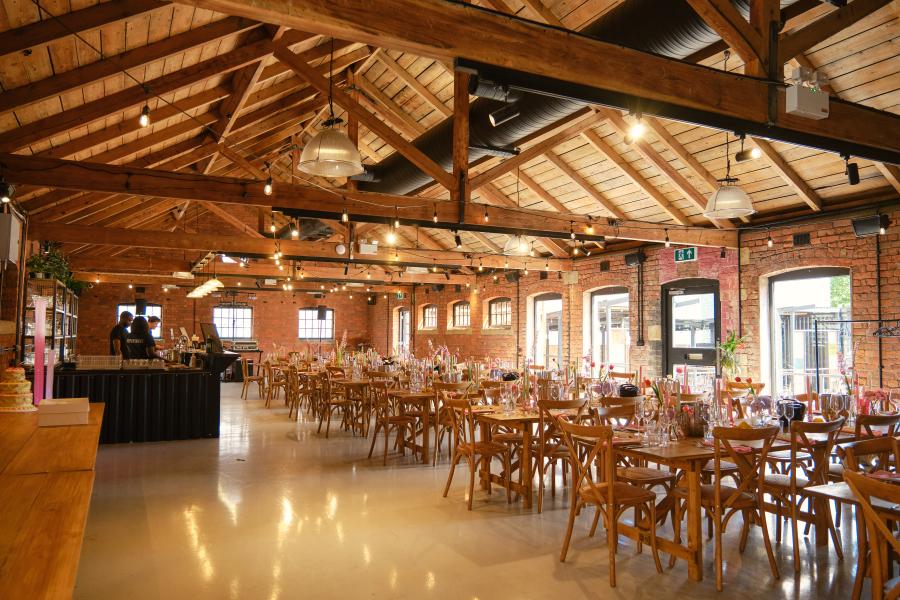 Event space in KickSonic with rustic beams, perfect for banquets and gatherings.