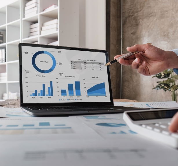 Professional analyzing data on laptop for event planning, focusing on key metrics and strategy.