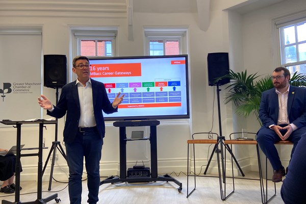 Dynamic speaker engaging audience at Education in Manufacturers Network event.