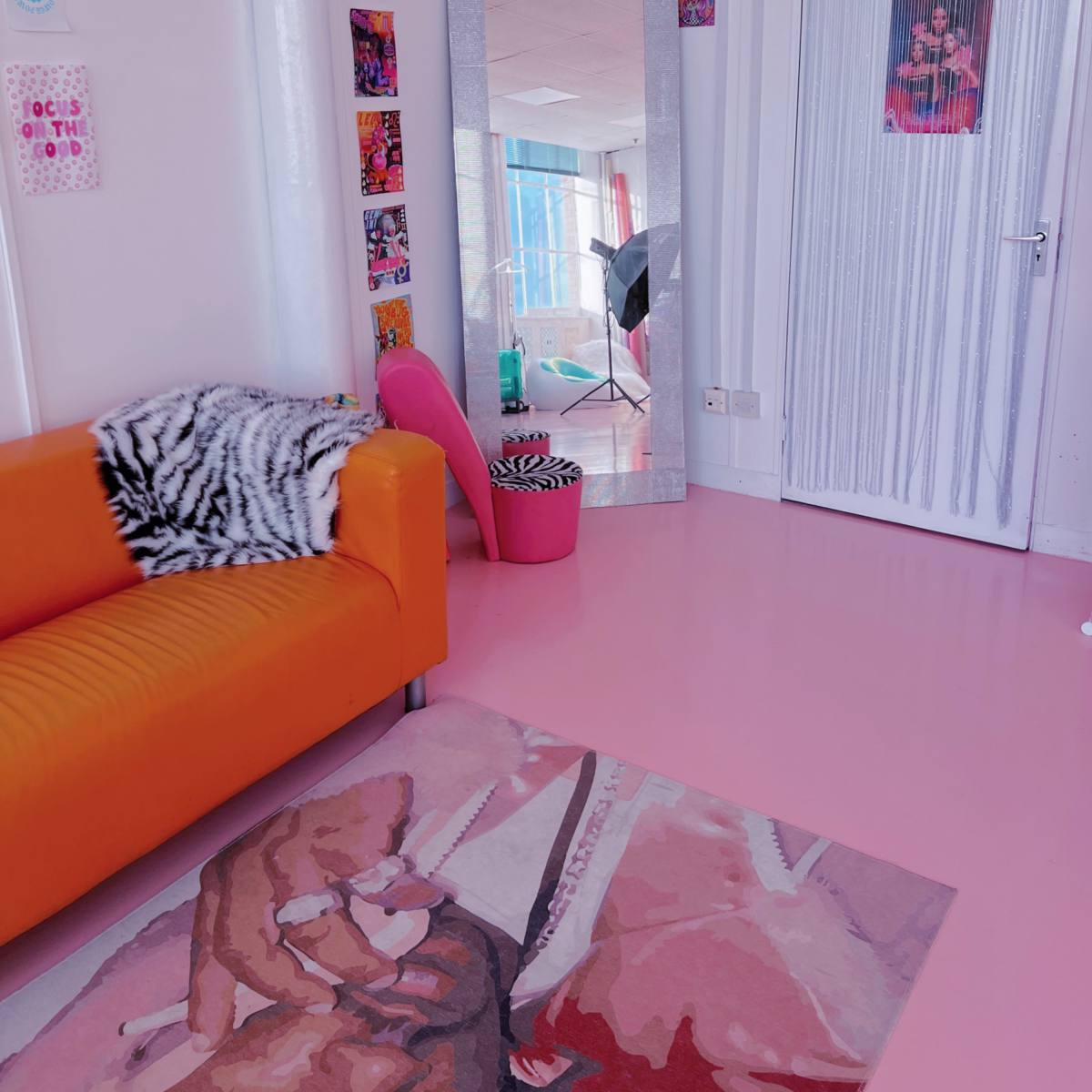 Vibrant Indigo Dreams Studio with orange sofa, ideal for creative meetings and workshops.