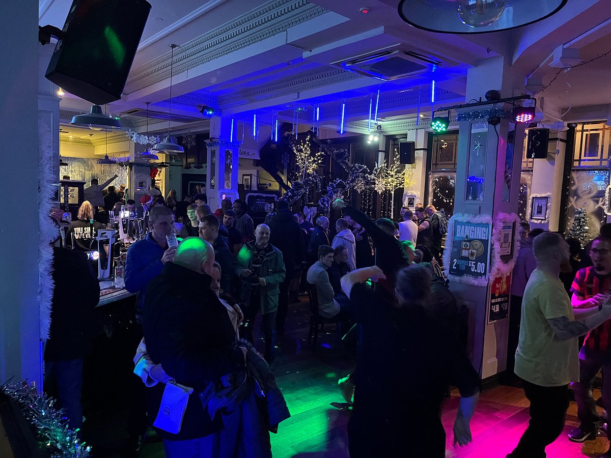 Lively Main Bar at The Town Hall Tavern with vibrant lights, perfect for networking event.