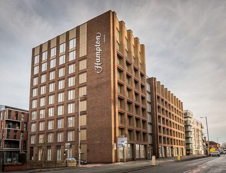 Modern hotel exterior of Hampton by Hilton Manchester, ideal for corporate events and meetings.