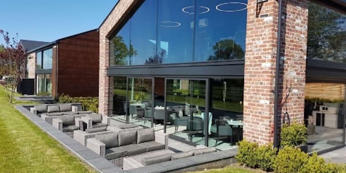 Modern HQ Lounge in The Colony with glass windows and inviting outdoor seating for events.