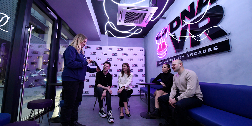 Video arcade at DNA VR with neon signage ideal for corporate events and team-building activities.