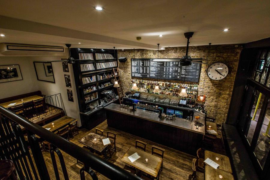 Cozy basement venue with rustic decor for intimate gatherings and casual meetings.