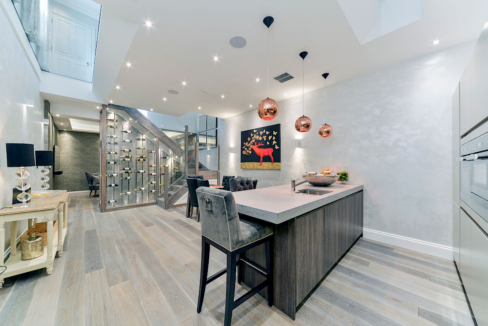 Modern kitchen with copper lighting, perfect for intimate gatherings and events.