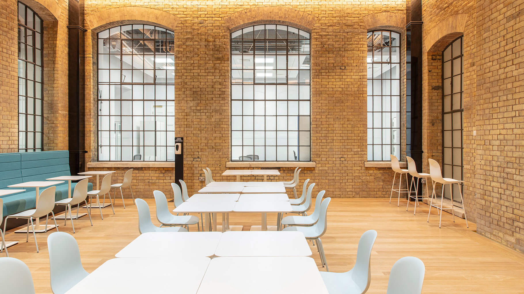 Spacious Basement Room with exposed brick walls, ideal for workshops and networking events.