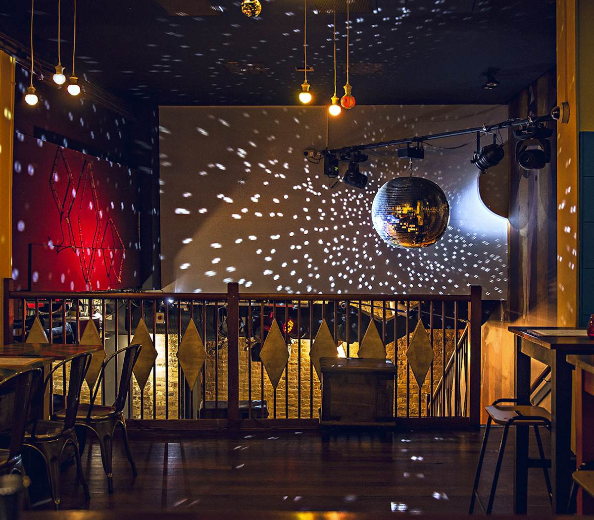 Elegant Mezzanine event space with polished wood floor, ideal for parties and celebrations.