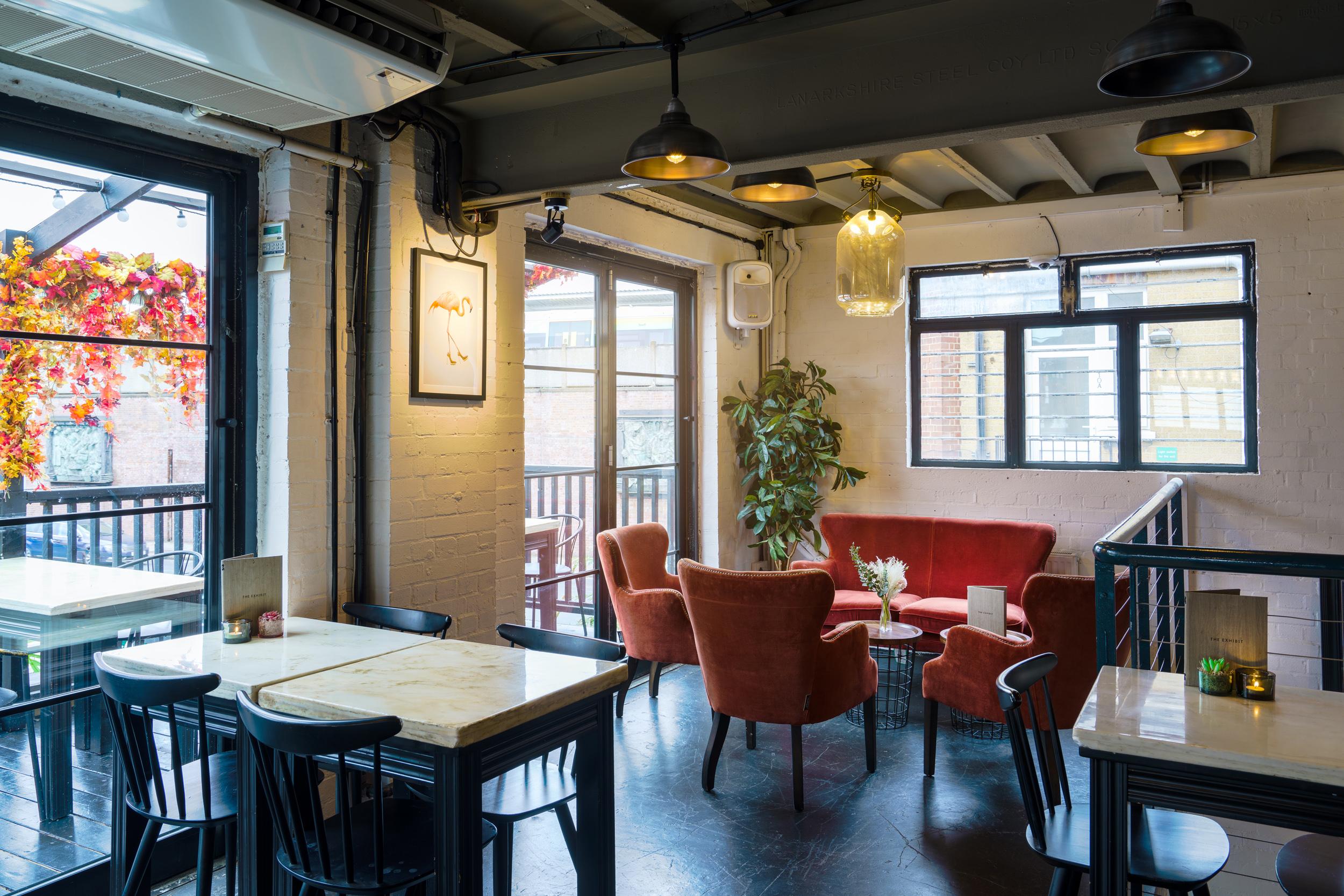 Stylish Mezzanine meeting space with cozy seating, ideal for networking events and gatherings.