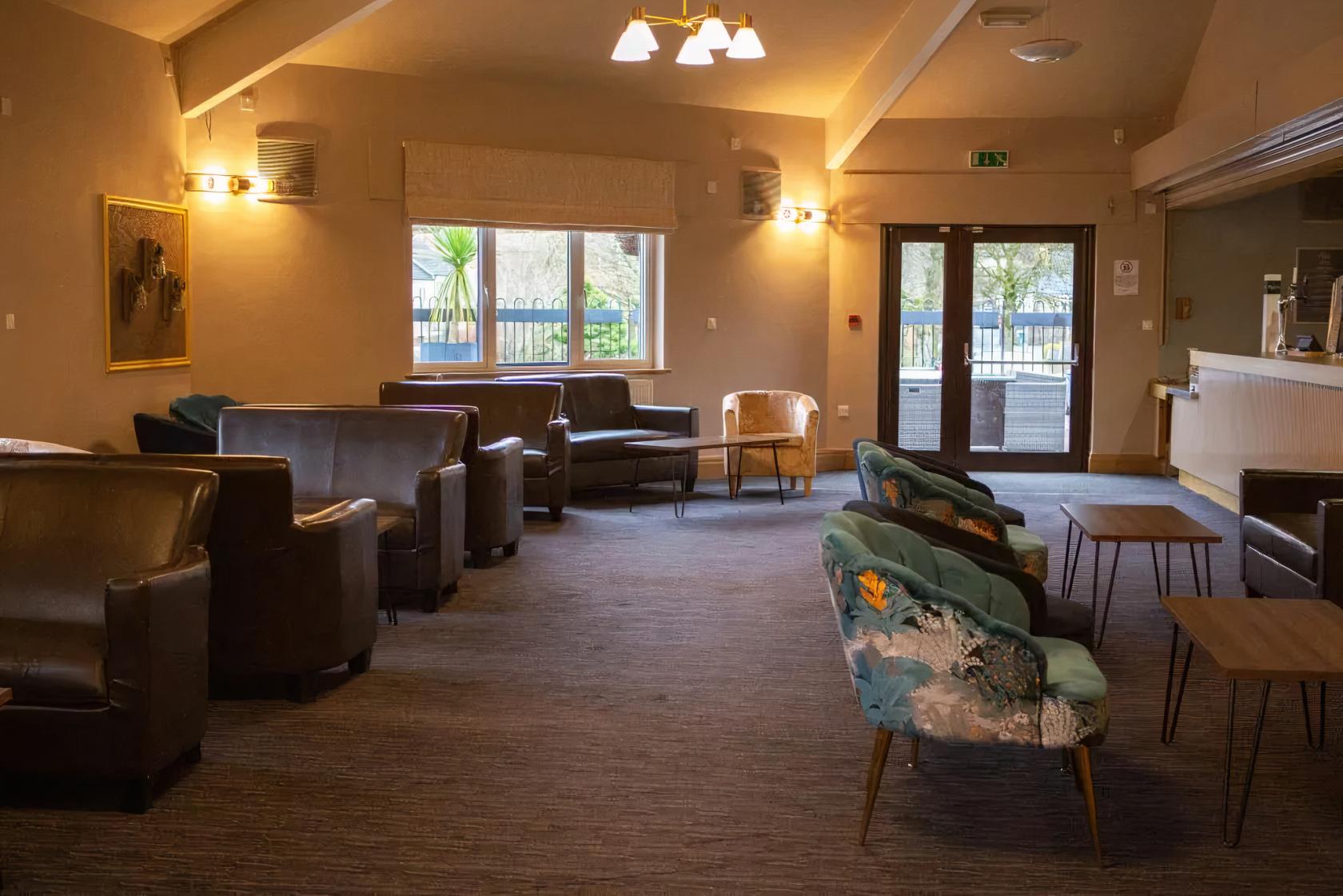 Cozy Main Hall meeting space with stylish seating for casual workshops and events.