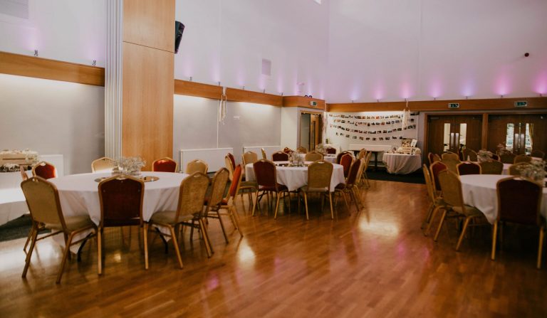 Elegant function room with round tables, ideal for weddings and formal events.