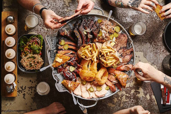 Rustic communal dining at Red's True Barbecue Leeds for casual networking and celebrations.