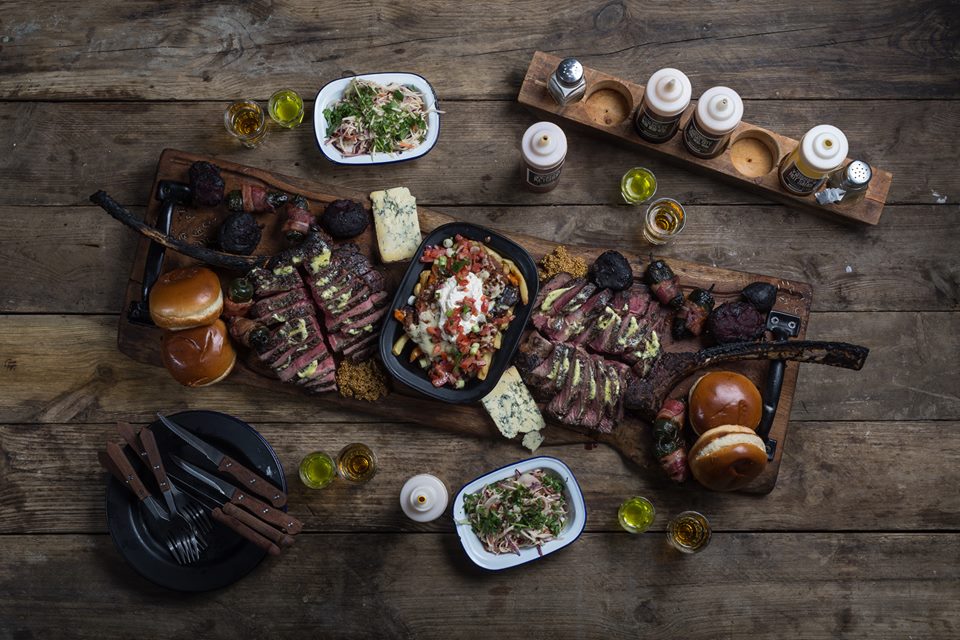 Rustic meat platter at Red's True Barbecue, perfect for corporate gatherings and celebrations.